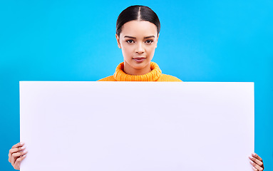 Image showing Studio, blank sign and portrait of woman with info and mockup isolated on blue background. Marketing, advertising and gen z girl with poster for product placement or news announcement mock up space.