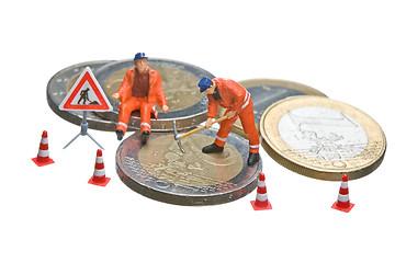 Image showing Miniature figures working on a heap of Euro coins.