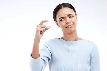 Image showing Woman, hand and small sign in studio with size, gesture or symbol against white background. Little, icon and finger emoji by girl disappointed on mockup with scale, review or opinion while isolated