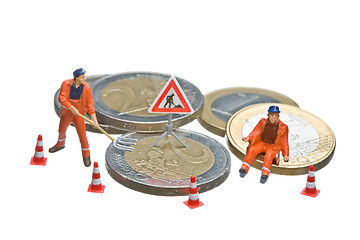 Image showing Miniature figures working on a heap of Euro coins.