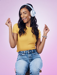 Image showing Music, headphones and Indian woman dance on pink background listening to track, audio and radio. Relax, happy and isolated girl singing streaming song for dancing, chilling and happiness in studio