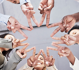 Image showing Hands, star and together in low angle for business people with teamwork, motivation and solidarity in office. Women, happiness and peace sign with shape, team building and support for company goals