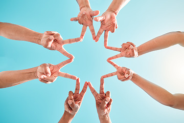 Image showing Hands, star and group of people in teamwork, collaboration and support outdoors in a circle for solidarity together. Fingers, community and team making hand sign or shape in the sunshine