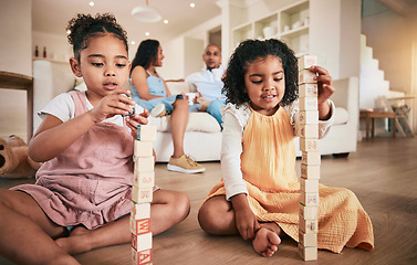 Image showing Toys, building blocks and children on a living room floor for bonding, learning and having fun with parents. Family, education and block activity by kids with creative cubes for development at home