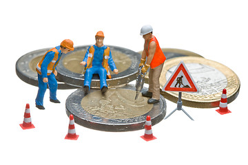 Image showing Miniature figures working on a heap of Euro coins.