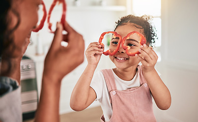 Image showing Food, cooking and mother and girl play together for learning, child development and bonding in kitchen. Family home, vegetables and mom and child having fun in meal prep for lunch, dinner and supper