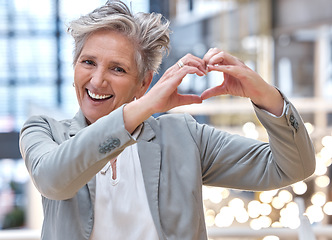 Image showing Business, heart and hands with portrait of woman in office for support, kindness and target. Corporate, goal and happy with senior female and positive gesture for success, achievement and motivation