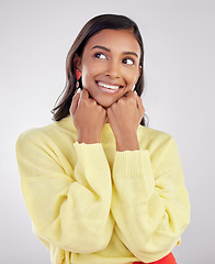 Image showing Face, thinking and excited with a woman on a white background in studio closeup to decide on a choice. Head, idea and smile with an attractive young female contemplating a thought about her options