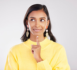 Image showing Face, idea and smile with a woman on a white background in studio closeup to decide on a choice. Head, thinking and happy with an attractive young female contemplating a thought about her options