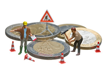 Image showing Miniature figures working on a heap of Euro coins.