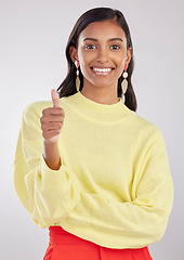 Image showing Portrait, thumbs up and fashion with a woman in on a gray background studio to promote contemporary clothes. Thank you emoji, motivation and style with an attractive female indoor to model clothing