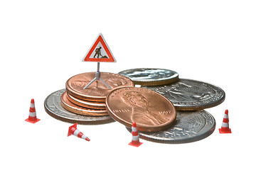 Image showing Miniature figures working on a heap of Dollar coins.