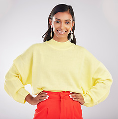 Image showing Happy woman, portrait smile and confidence standing isolated with hands on hips against a gray studio background. Face of stylish and confident Indian female posing and smiling in colorful fashion