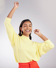 Image showing Happy, excited and woman dance, celebration and cheerful against a grey studio background. Female dancer, model and person moving, groove and happiness with routine, motivation and stress relief