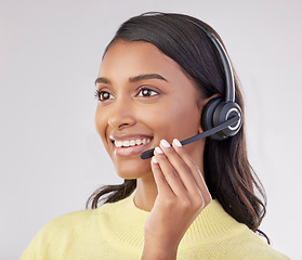 Image showing Happy woman has smile on face, callcenter and headset with mic, CRM and contact us with consultant on studio background. Indian female, customer service agent and help desk with tech support worker