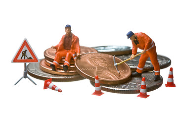 Image showing Miniature figures working on a heap of Dollar coins.