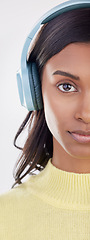 Image showing Serious, half and portrait of a woman with headphones for music isolated on a white background. Cropped, young and an Indian girl listening to audio, streaming radio or podcast on a backdrop