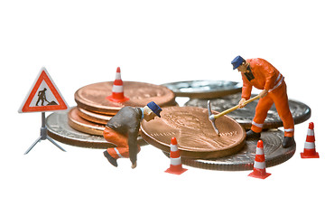 Image showing Miniature figures working on a heap of Dollar coins.