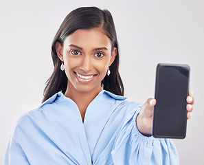 Image showing Phone, studio and portrait of Indian woman with smile for advertising, promotion and mockup screen. White background, happy and face of girl with smartphone for social media, website and mobile app