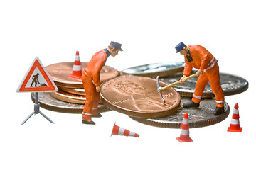 Image showing Miniature figures working on a heap of Dollar coins.