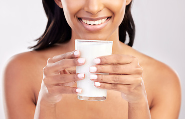 Image showing Woman with smile, glass of milk in hands and health with nutrition, vitamins and calcium on studio background. Organic, healthy lifestyle and wellness with happy female, diet and dairy product