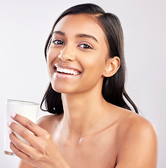 Image showing Woman with smile in portrait, glass of milk and health with nutrition, vitamins and calcium on studio background. Organic, healthy lifestyle and wellness with happy female, diet and dairy product