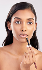 Image showing Woman apply lip liner, face and portrait with makeup, beauty and cosmetic product on studio background. Indian female, cosmetics pencil for lips and lipstick with healthy skin and cosmetology