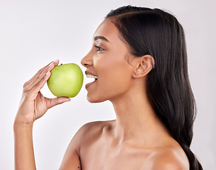 Image showing Woman, apple and face profile, health nutrition and fruit with healthy food and detox diet on studio background. Weight loss, organic and fresh produce with happy female mouth, wellness and lifestyle