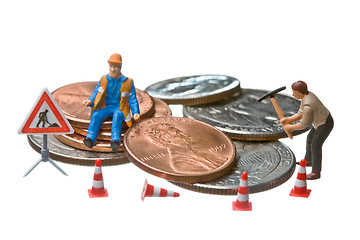 Image showing Miniature figures working on a heap of Dollar coins.