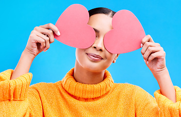 Image showing Heart eyes, cover and woman smile with happiness and excited for love, valentines day or studio emoji. Happy, loving or person on isolated blue background, creative romance paper and show care symbol