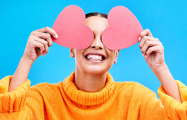 Image showing Heart eyes, cover and woman with happiness and excited about love, valentines day or emoji. Happy, smile and person with isolated blue background, loving or creative romance paper symbol to show care