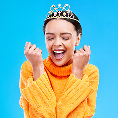 Image showing Winner, crown and portrait of woman in studio for celebration, princess and success. Smile, beauty and fashion with female tiara on blue background and excited for achievement, pageant and prom event