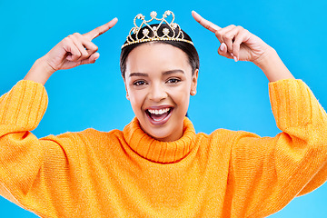 Image showing Pointing, tiara or portrait of woman hands in studio celebration, princess or dress up party. Smile, beauty or fashion with female crown on blue background and excited for achievement, winner or prom