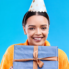 Image showing Woman, birthday and box in studio portrait with smile, happiness and present by blue background. Girl, model and party with gift, hat and excited face for celebration, event and package by backdrop