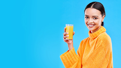 Image showing Orange juice, happy and portrait of woman in studio and mockup for nutrition, health and diet. Vitamin c, fruit and fresh with female drinking on blue background for citrus, fiber or organic beverage