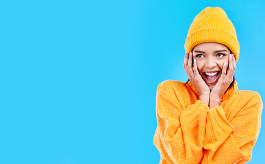 Image showing Happiness, surprised and woman hands on studio mockup ready for cold weather with winter fashion. Isolated, blue background and surprise emoji with a happy, young and gen z person with wow and smile