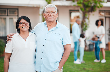 Image showing Outdoor, portrait and senior couple by their house embracing while bonding with their family. Love, smile and happy elderly man and woman in retirement standing in the backyard of their modern home.