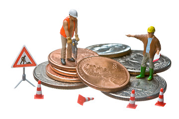 Image showing Miniature figures working on a heap of Dollar coins.