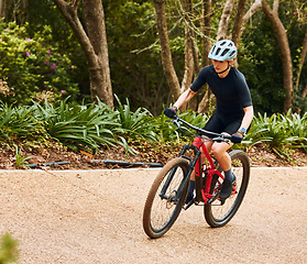 Image showing Fitness, nature and woman riding a bicycle while training for a race, marathon or competition. Sports, workout and female athlete cyclist doing a cardio exercise on a bike on an outdoor trail in park