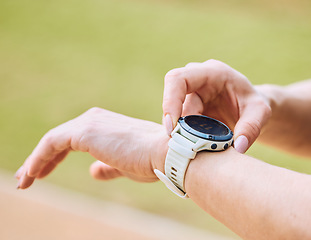 Image showing Hands, exercise and smart watch with a sports person outdoor, checking the time during a workout. Arm, fitness and technology with an athlete tracking cardio or endurance performance while training