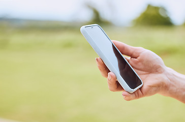 Image showing Hand, phone and person use gps online on mobile app to navigate on a field with internet connection for a smartphone. Cellphone, mockup and closeup of web search on a website outdoors in nature