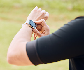 Image showing Hands, fitness and smart watch with a sports person outdoor, checking the time during a workout. Arm, exercise and technology with an athlete tracking cardio or endurance performance while training