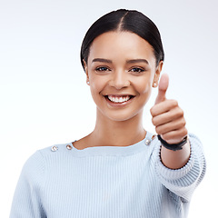 Image showing Portrait, thumbs up and motivation with a woman on a white background in studio for feedback or success. Winner, emoji or hand gesture with an attractive young female saying thank you to show support