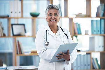 Image showing Senior woman doctor, portrait and checklist in clinic for inspection, healthcare paperwork or report. Female medic, clipboard and documents for results, analysis or diagnosis with smile at hospital