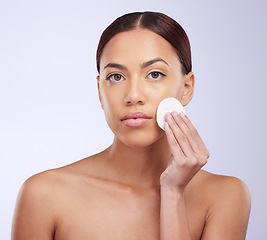 Image showing Portrait, skincare and cotton pad with a woman in studio on a gray background for natural treatment or beauty. Facial, wellness and anti aging with an attractive young female exfoliating her face