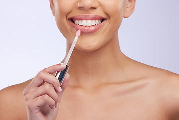 Image showing Closeup, smile and woman with skincare, lip gloss and cosmetics isolated on a white studio background. Zoom, female model and person with makeup product, lipstick and happiness with beauty and glow