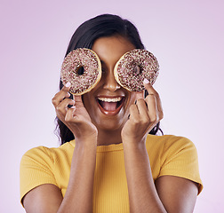 Image showing Donut, dessert and cover with woman in studio for diet, snack and happiness. Sugar, food and smile with female hiding and isolated on pink background for nutrition, playful and craving mockup