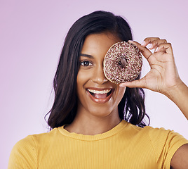 Image showing Donut, cover with portrait of woman in studio for diet, snack and happiness. Sugar, food and smile with female hiding and isolated on pink background for nutrition, playful and craving mockup