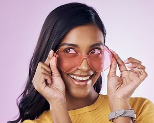 Image showing Glasses, sunglasses and cool woman excited, happy and confident isolated in a pink studio background with joy. Vision, thinking and young gen z female with stylish frames with a positive energy