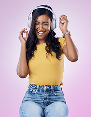 Image showing Music, headphones and excited Indian woman dance on pink background listening to track, audio and radio. Relax, happy and isolated girl streaming song for dancing, chilling and happiness in studio